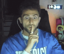 a man wearing a blue shirt that says ' dicy ' on it