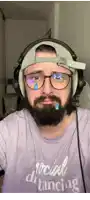 a man with a beard wearing headphones and a purple shirt that says social distancing