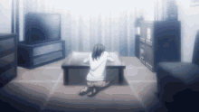 a woman is kneeling down in front of a television