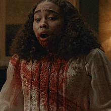 a woman with blood on her face is making a face