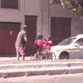 a woman in a wheelchair is being pushed by a man