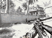 a black and white photo of a person holding a sniper rifle with the word just in the corner