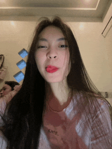 a woman wearing a pink shirt that says ' i love you ' on it