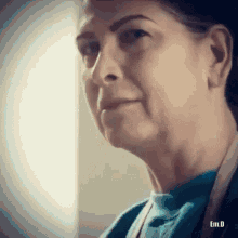 a close up of an elderly woman 's face with a serious look on her face .