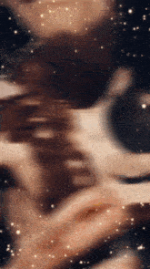 a blurry picture of a person 's face with a lot of stars