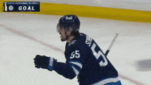 a hockey player with the number 55 on his jersey is celebrating a goal