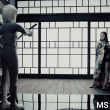 a woman in a kimono is standing in front of a sliding glass door with the letters ms on the bottom