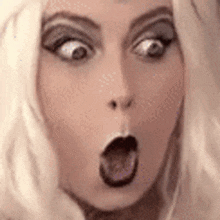 a woman is making a surprised face with her mouth open .