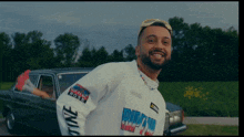 a man wearing a white shirt with the word dirty on the sleeve