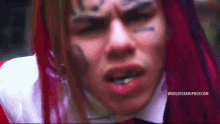 a close up of a man 's face with the words worldstarhiphop.com written on the bottom