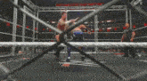 a wrestling ring with a fence and a sign that says wrestlemania