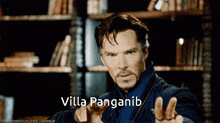 a man in a blue robe is pointing at the camera with the words villa panganib written below him