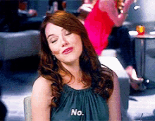 a woman wearing a green top that says no