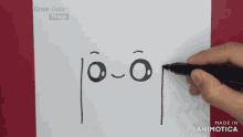 a person is drawing a face on a piece of paper with a marker