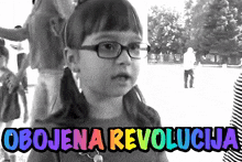 a little girl wearing glasses stands in front of a sign that says obojena revolucija