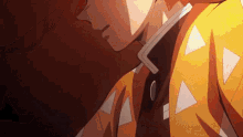 a close up of a person wearing a yellow jacket with white triangles on it .