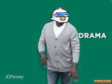 a man wearing a grey cardigan and jeans stands in front of a green background with the word anxiety written on it