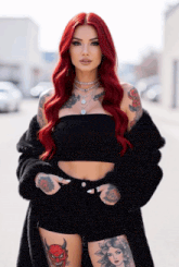 a woman with red hair and many tattoos is wearing a black fur coat