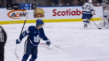 a hockey game is being played in front of a scotiabank sign