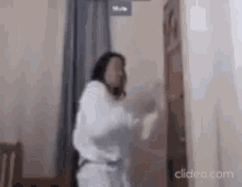 a woman is standing in a room next to a door .