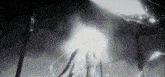 a person is standing in the dark with a light coming out of their back