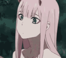 a close up of a pink haired anime girl with horns and green eyes .