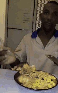 a man is holding a knife and a plate of food