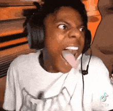 a person wearing headphones is sticking their tongue out
