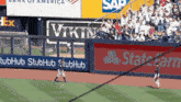 a baseball game is being played in front of a bank of america and sap advertisement