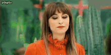 a woman in a red shirt is making a funny face .