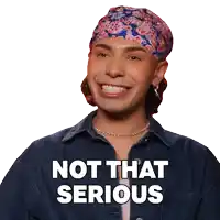 a man wearing a headband and a denim jacket is smiling and says " not that serious "