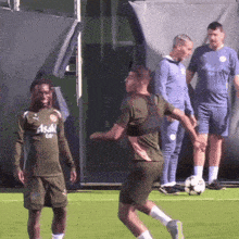 a soccer player wearing a green asahi jersey kicks a ball
