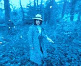 a man in a hat is walking through a green forest