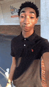 a young man taking a selfie in front of a sign that says ' civic '