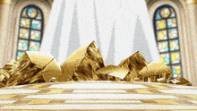 a bunch of gold rocks on a table in front of a window