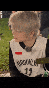 a person wearing a brooklyn jersey with the number 11