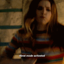 a woman is wearing a striped shirt and says #brat mode activated