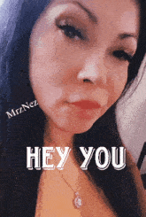 a close up of a woman 's face with the words hey you on the bottom