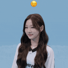 a girl with a smiley face on her head is smiling