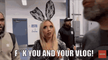 a woman wearing bunny ears says " f * k you and your vlog " in front of a group of people