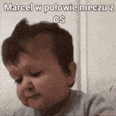 a baby making a funny face with the words marcel w połowie meczu z cs above him