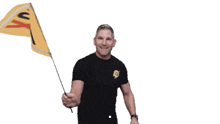 a man in a black shirt is waving a yellow flag with the number 10k on it