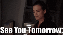 a woman in a dark room with the words see you tomorrow