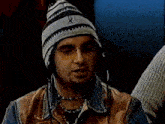 a man wearing a hat and glasses has the name chris kirkpatrick on the screen