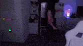 a person is dancing in a dark room with a purple light
