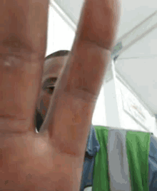 a close up of a man 's hand making a stop sign .