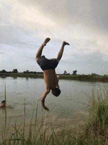 a man doing a handstand in the water