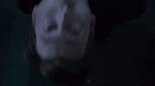 a close up of a person laying upside down with their mouth open