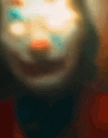 a close up of a person 's face with a clown makeup on