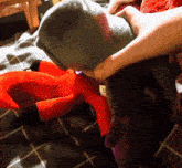 a person is holding a stuffed animal with a label on it that says ' a ' on it